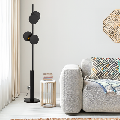 Modern living room with a black Amparo floor lamp, gray sofa, and decorative pillows from Australia's leading wholesale lighting supplier.